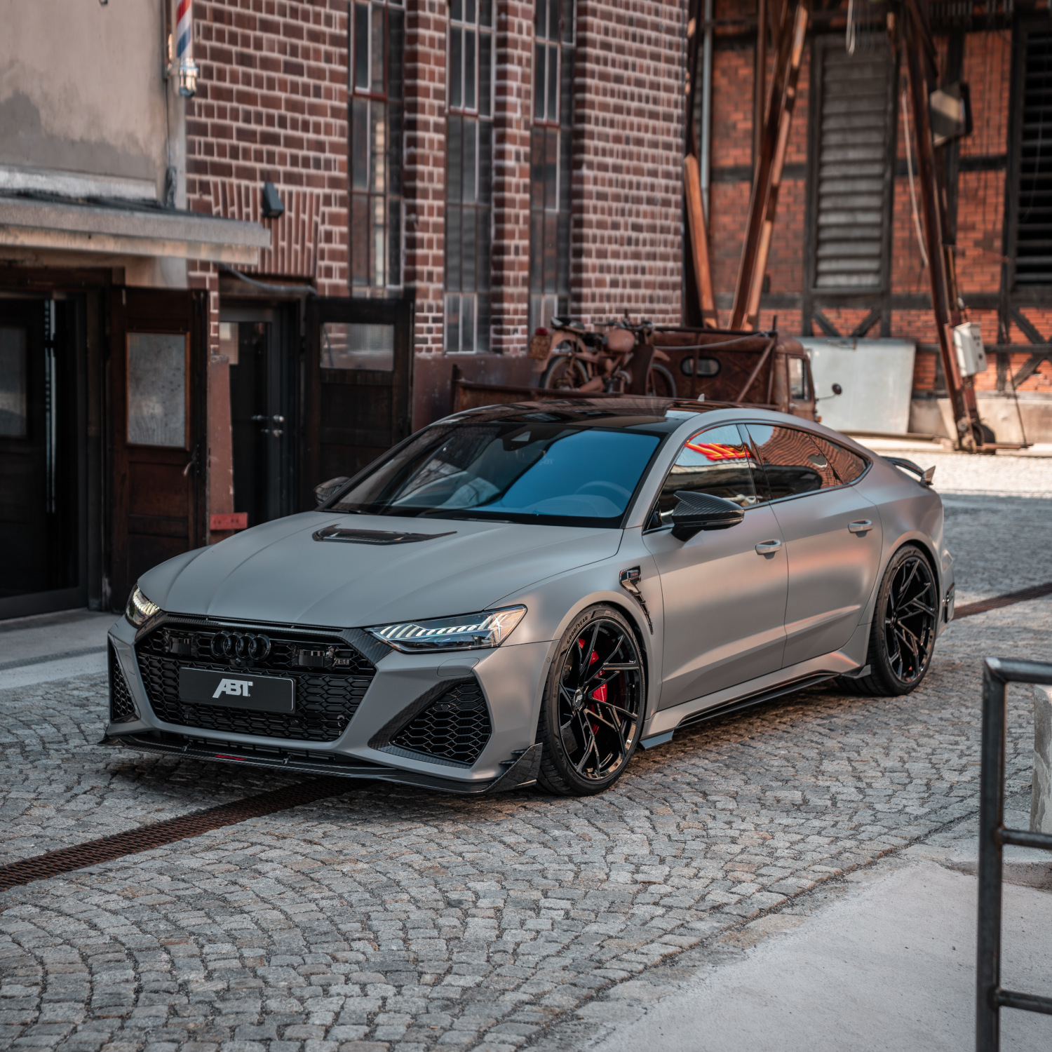 grey RS7-LE from the side front view in front of the building